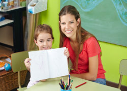 a girl and her teacher doing art